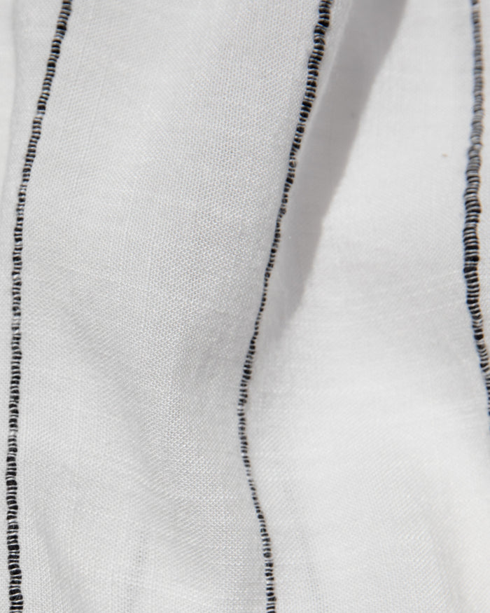 Close-up of the LSPACE Las Palmas Dress in fine line stripe, highlighting the lightweight woven fabric with fine black vertical stripes.