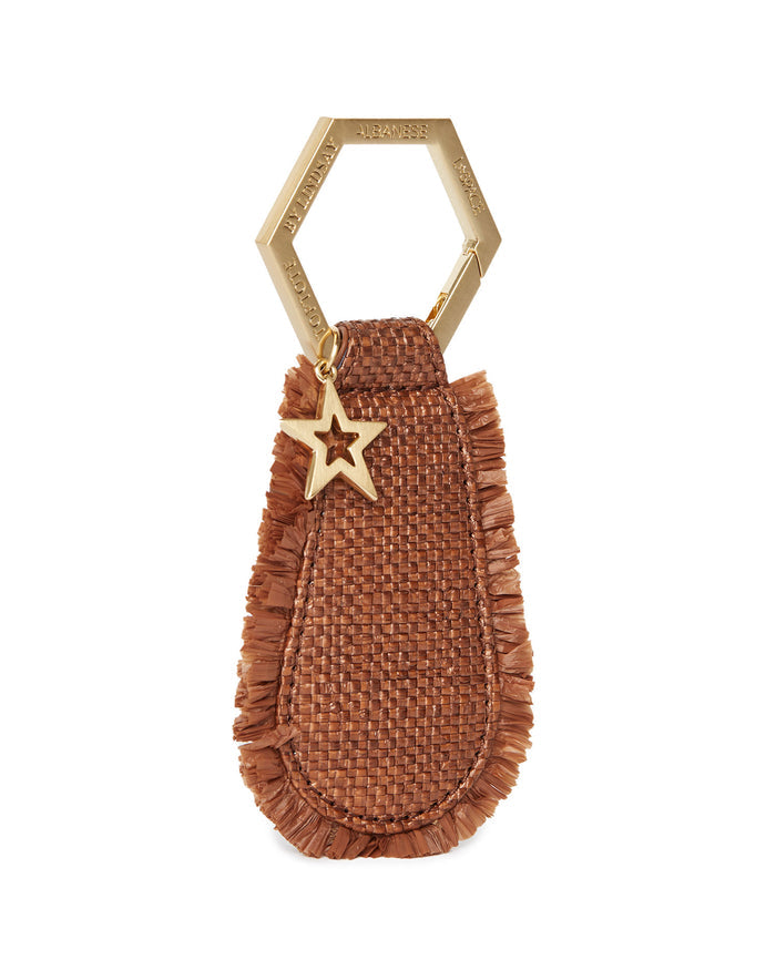 Front view of the LSPACE x Lindsay Albanese TOPTOTE in tobacco on a white background, showing the woven raffia pouch with fringe and gold hexagonal ring.