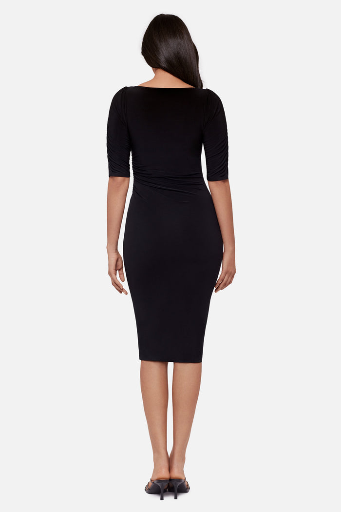 Woman turned away wearing a black half sleeve mid length dress