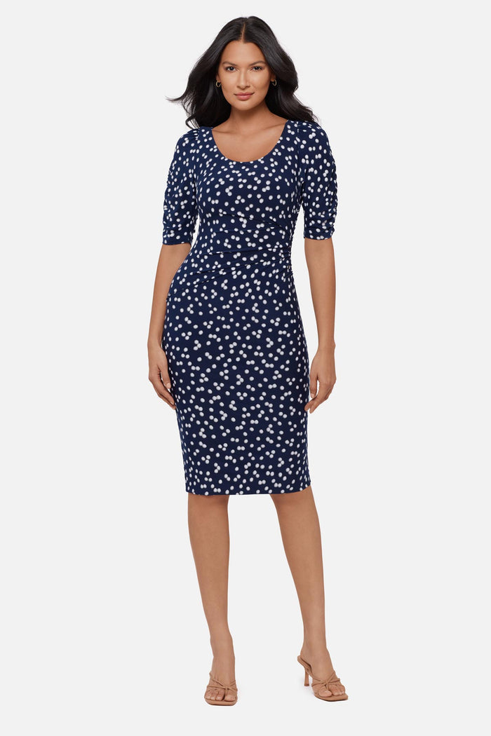 Woman wearing a dark blue and white polka dot half sleeve mid length dress