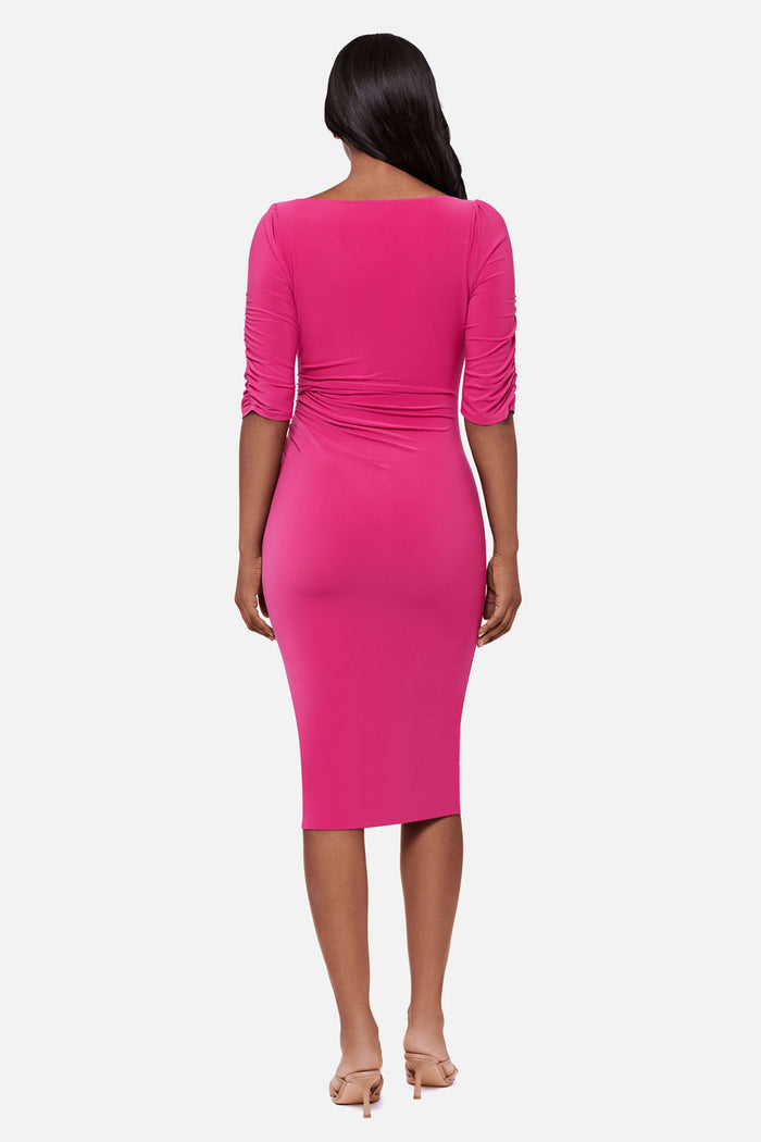 Woman faced away wearing a pink half sleeve mid length dress