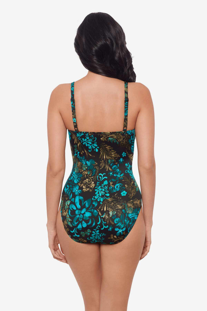 Woman facing away wearing a multicolor one-piece swimsuit