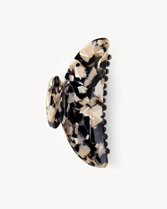 Off-model angled view of the Machete Midi Claw in abalone, a black and cream marble-patterned claw clip, on a white background.