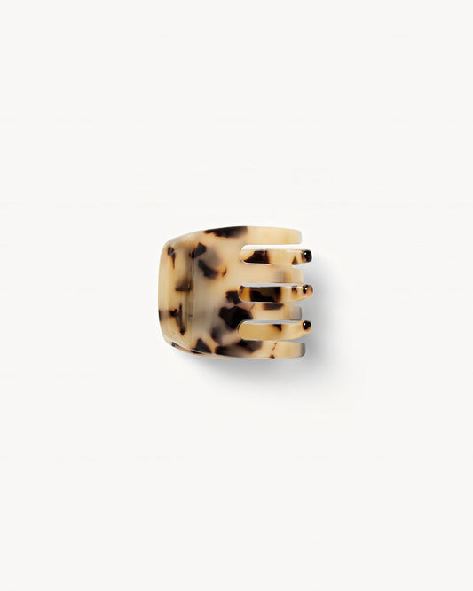 Off-model top-down view of the Machete Mini Claw in blonde tortoise showing the teeth and cream acetate with dark tortoise spots.
