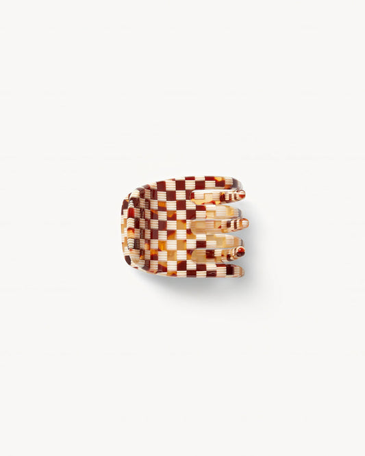 Off-model top-down view of the Machete Mini Claw in tortoise checker showing the teeth and tortoise and cream checkerboard acetate pattern.