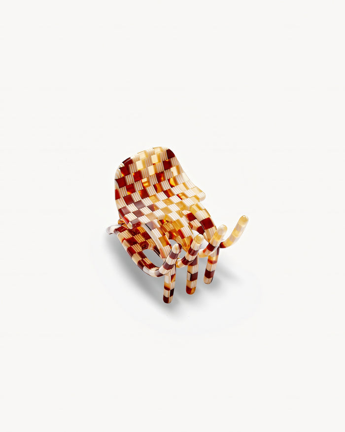 Off-model angled top-down view of the Machete Mini Claw in tortoise checker showing the front of the claw.