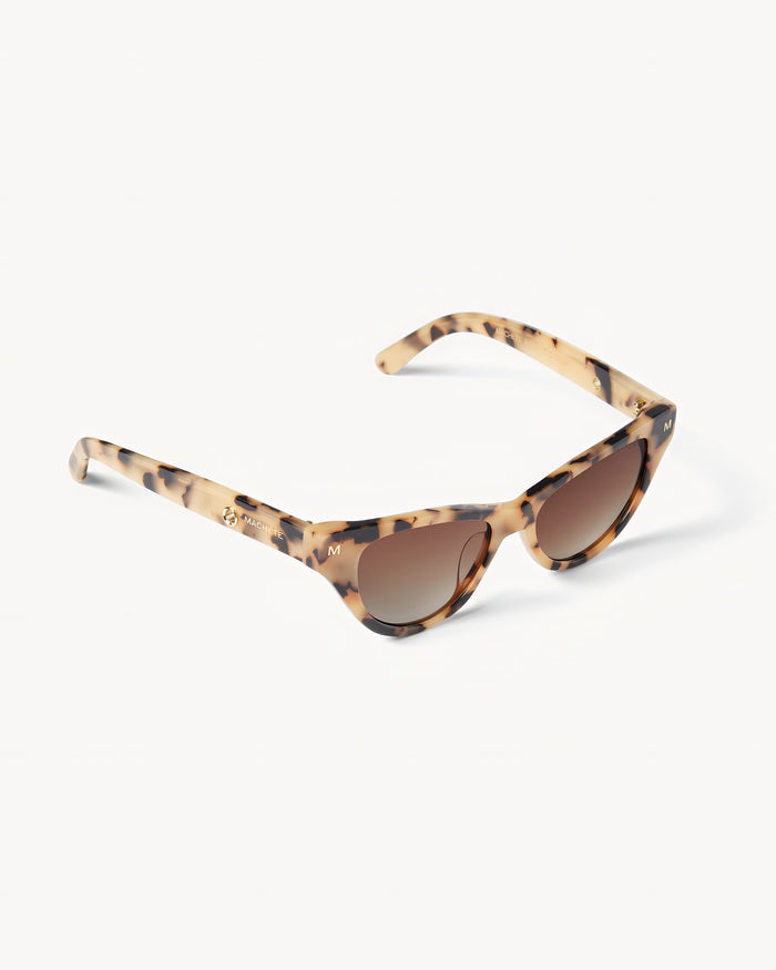Off-model angled view of the Machete Suzy Sunglasses in blonde tortoise showing the side profile of the cat-eye frame.