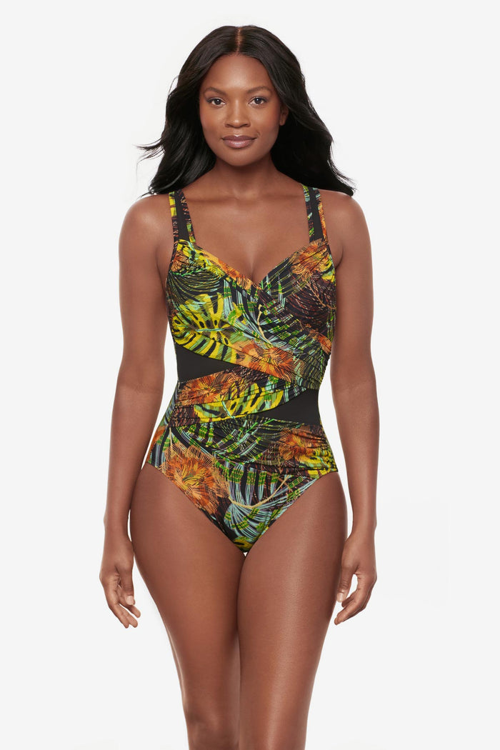 Woman wearing a multicolored palm leaf printed one-piece swimsuit