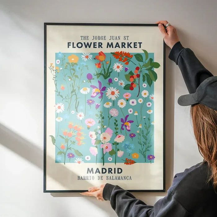 Madrid Flower Market Print being hung on a wall in a black frame