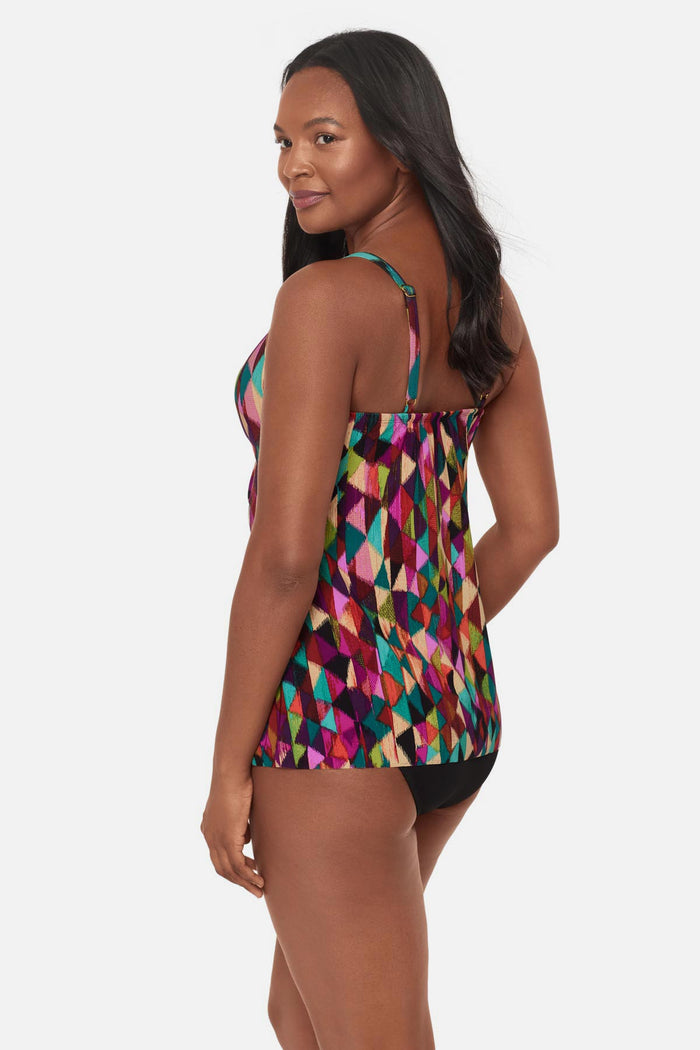 Woman turned left wearing a multicolored geometric printed tankini top