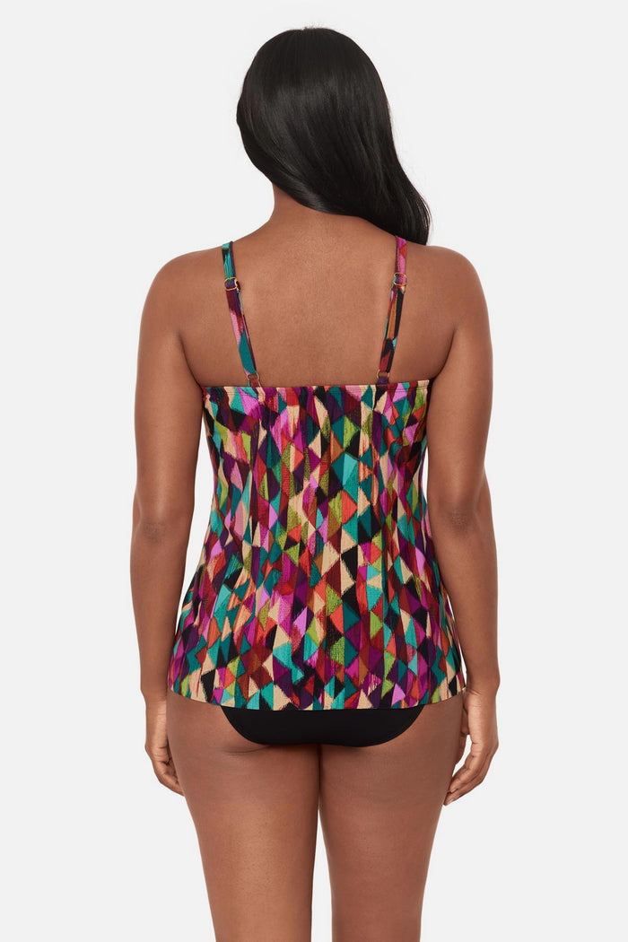 Woman turned away wearing a multicolored geometric printed tankini top