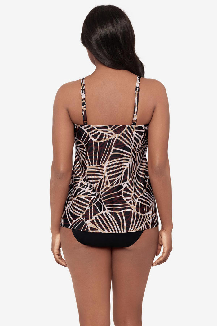 Woman turned away wearing a brown printed tankini top