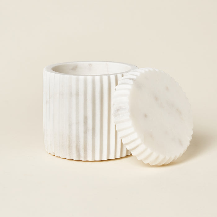 White marble fluted canister with a matching lid.