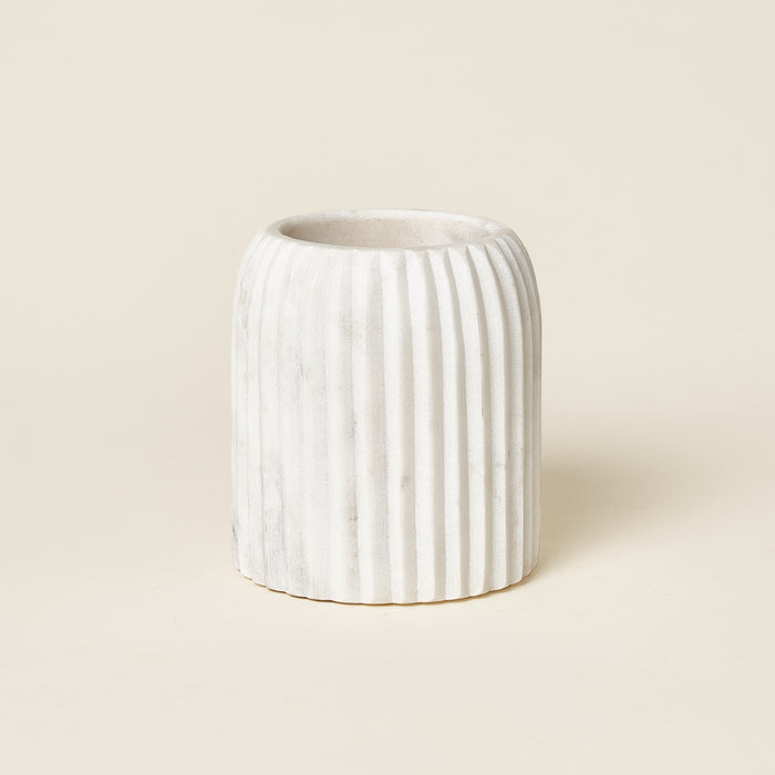 White marble fluted tumbler for bathroom storage.