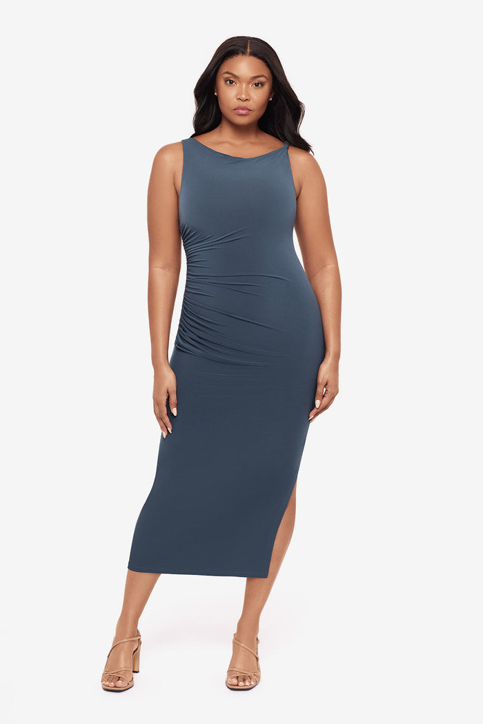 Woman wearing a slate grey maxi dress with ruching on the side