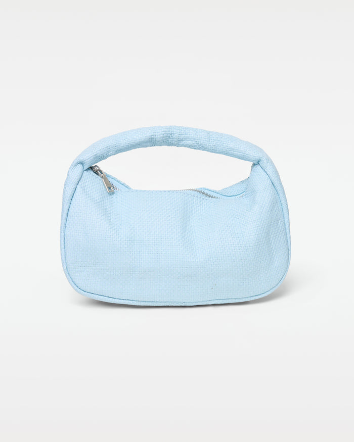 Off-model front view of the Mendoza Bag in sky blue, a structured woven crescent hobo bag with a short curved top handle and silver zipper closure, on a white background.