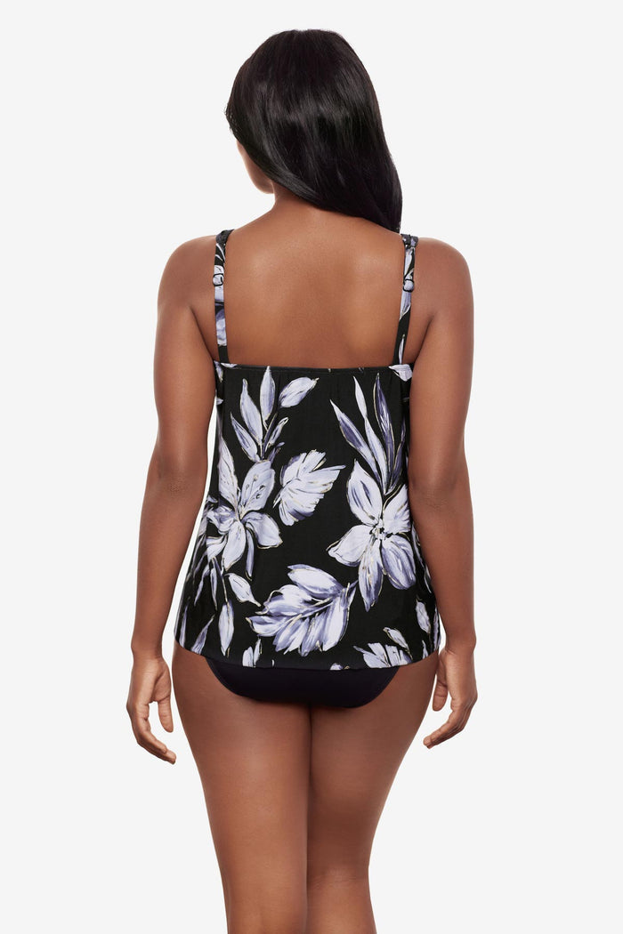 Woman turned away wearing a black and white floral printed tankini top