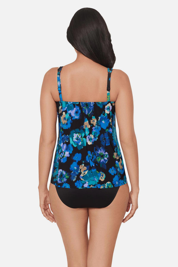Woman turned away wearing a black and blue floral printed tankini top
