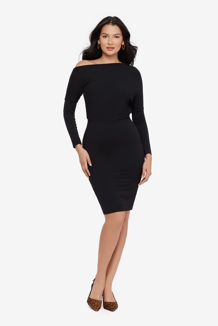 Woman wearing a black long sleeve dress at knee length