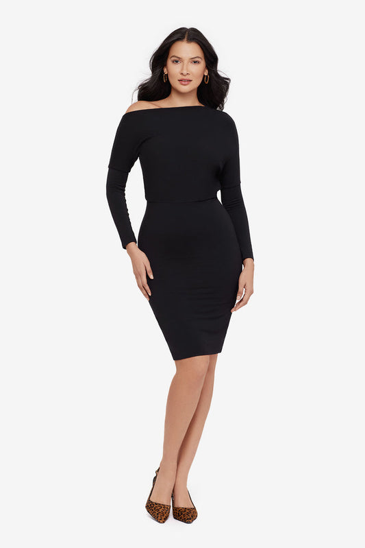 Woman wearing a black long sleeve dress at knee length