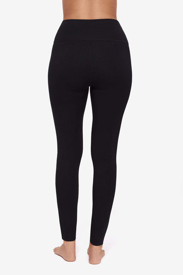 Close up of back of Woman's legs in black leggings