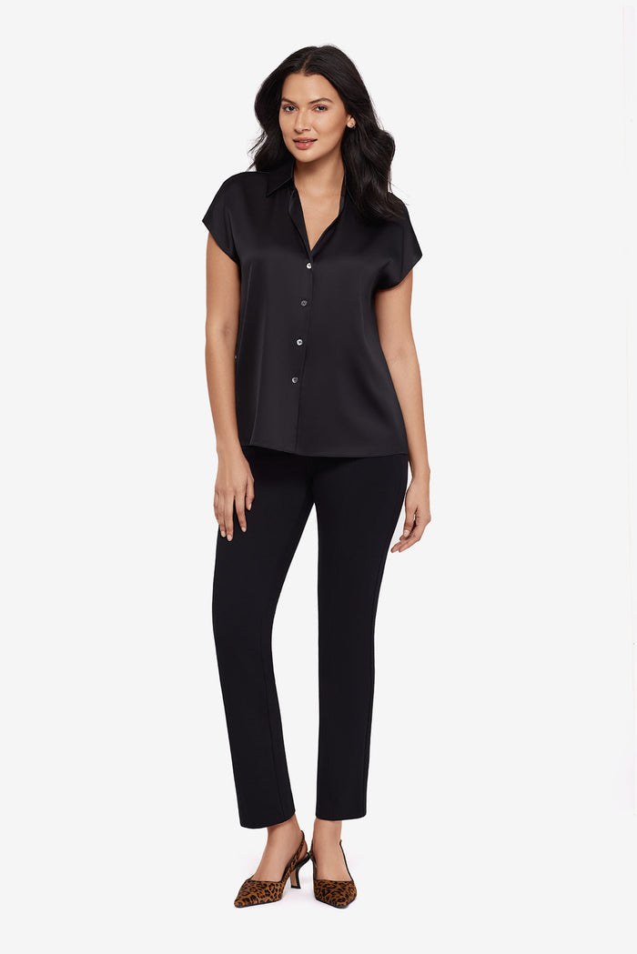 Woman wearing a black blouse with matching black slim fit pants