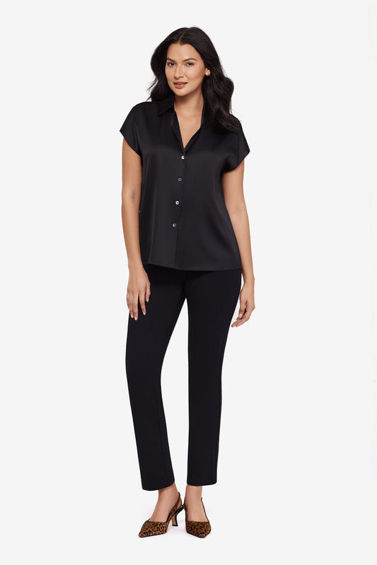 Woman wearing a black blouse with matching black slim fit pants