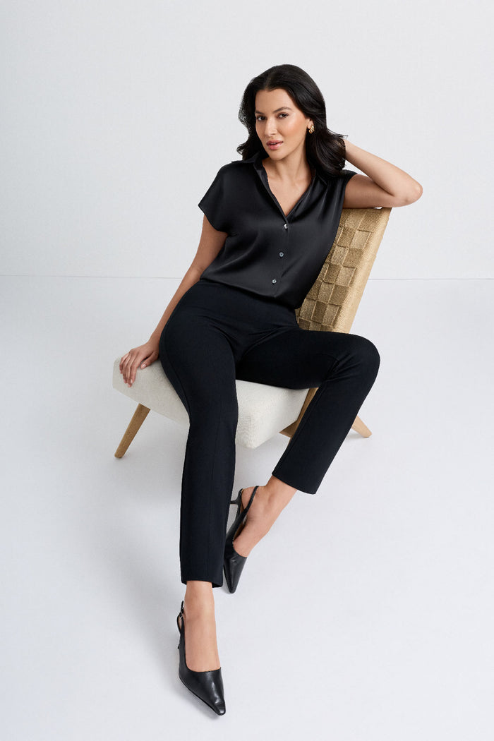 Woman sitting on chair wearing black slim fit pants