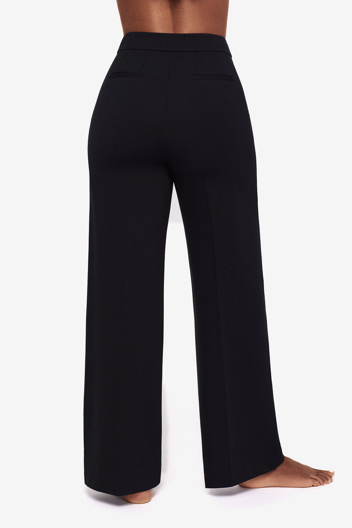 Close up of back of Woman's legs in black wide legs pants
