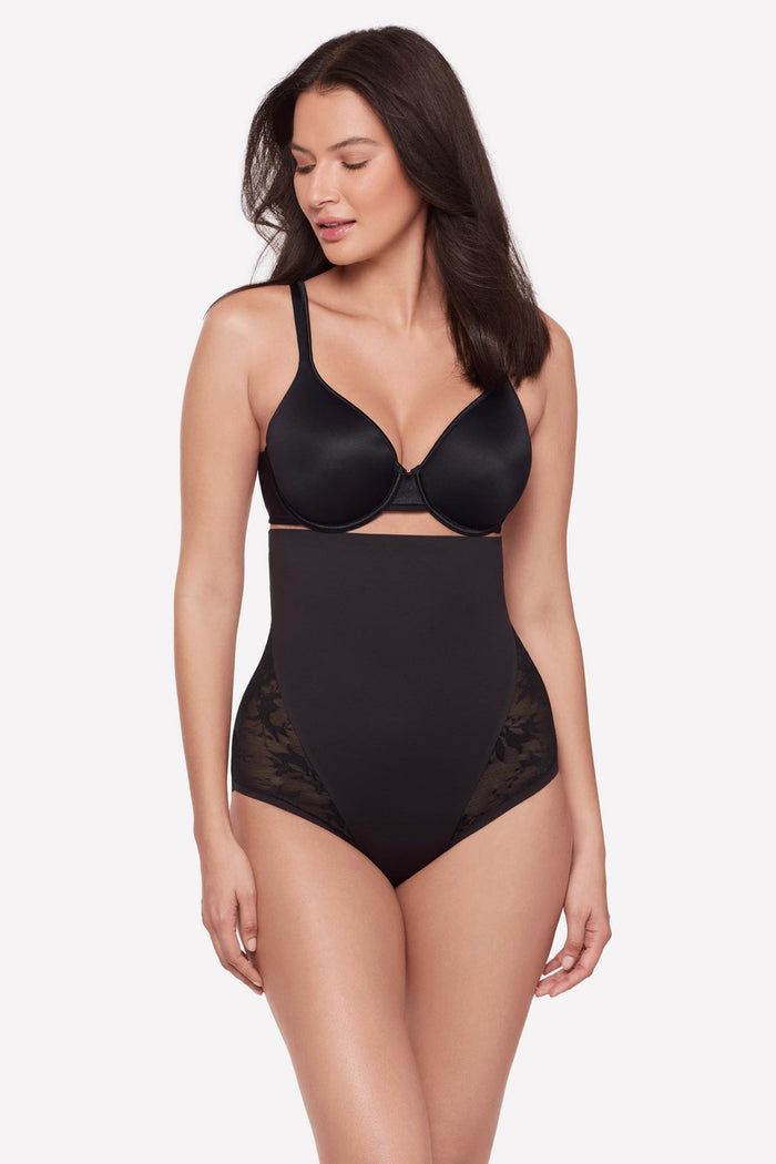 Woman wearing a black lacey high waisted shaping brief