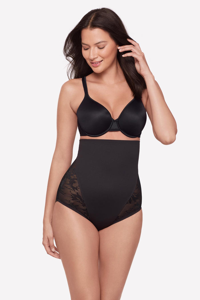 Woman wearing a black lacey high waisted shaping brief