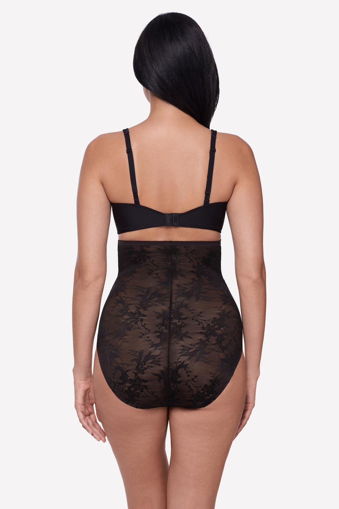 Woman turned away wearing a black lacey high waisted shaping brief