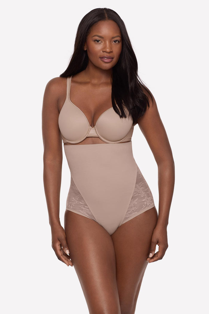Woman wearing a beige lacey high waisted shaping brief