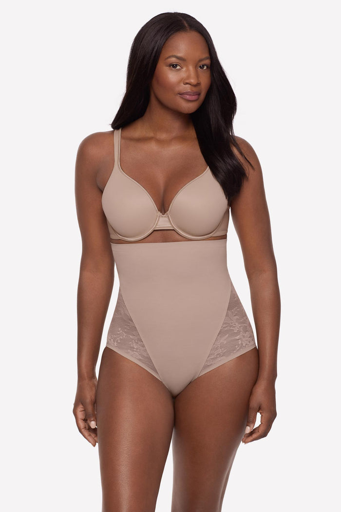 Woman wearing a beige lacey high waisted shaping brief
