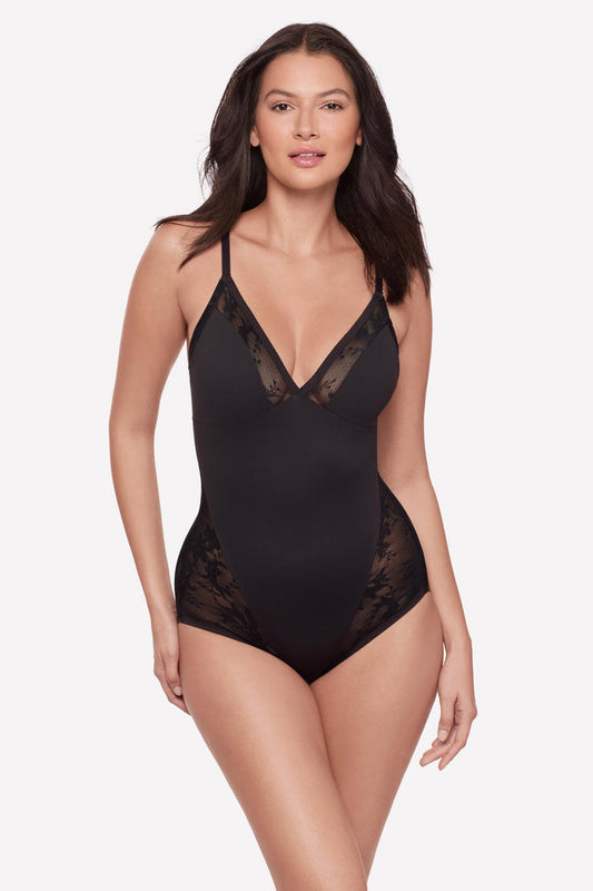 Woman wearing a black lacey one-piece bodysuit