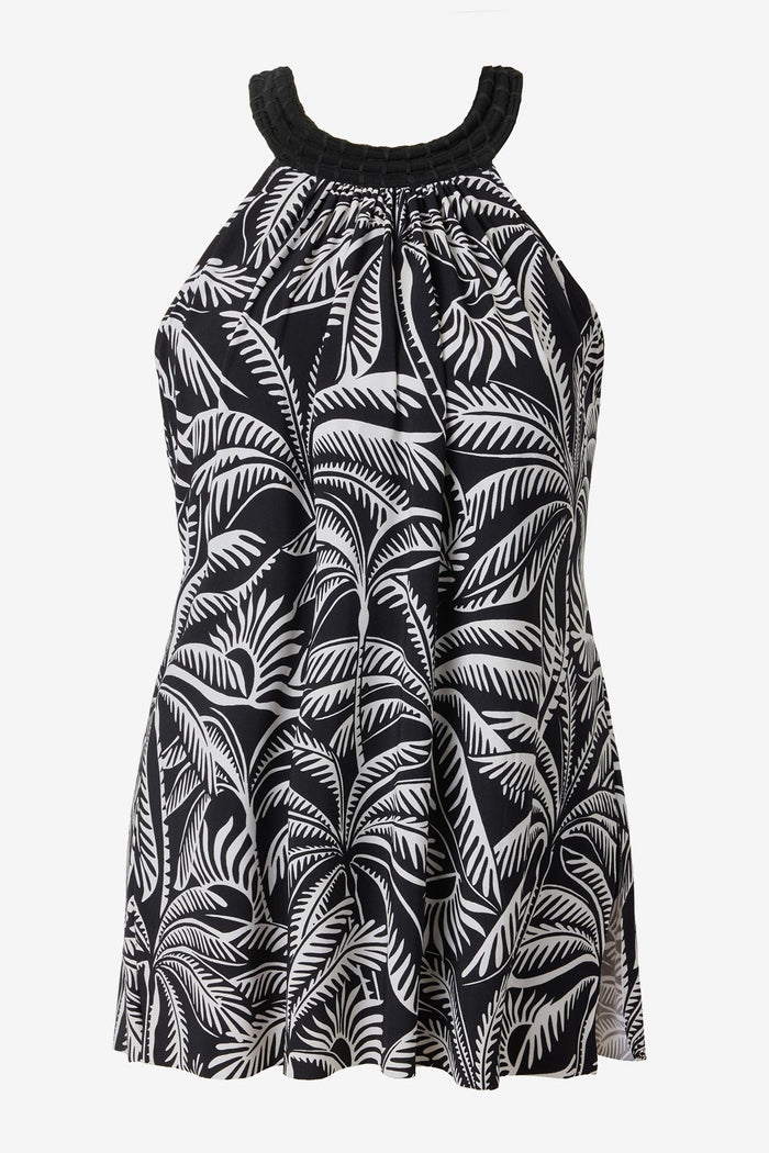 Woman wearing a black and white palm leaf printed swim dress