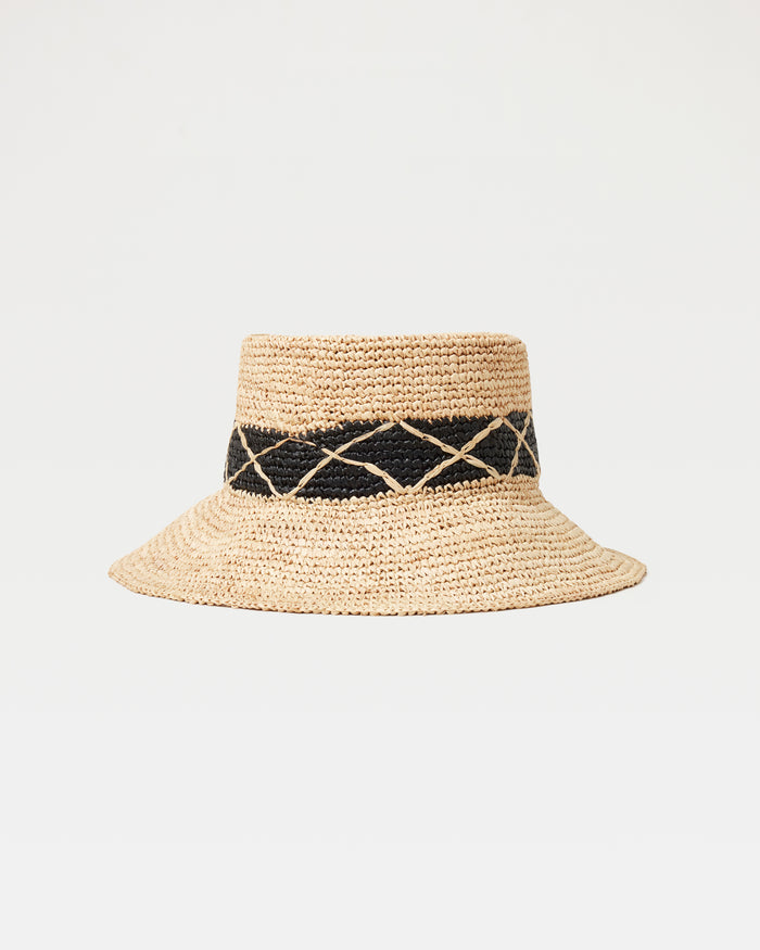 Off-model front view of the Montauk Bucket Hat in natural, a woven raffia bucket hat with a black diamond-patterned band, on a white background.