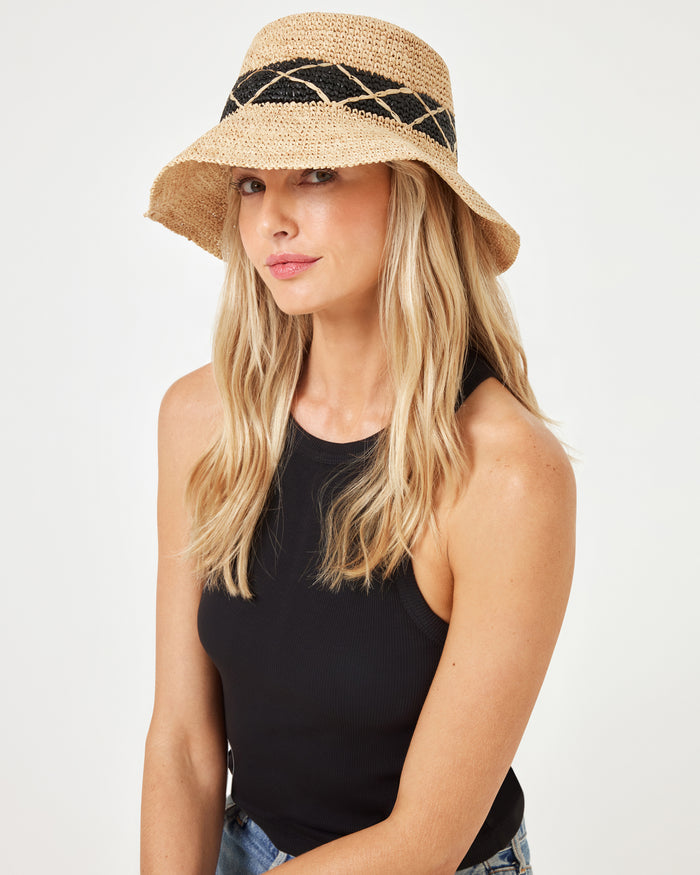 Front view of model wearing the Montauk Bucket Hat in natural, paired with a black sleeveless top and jeans.