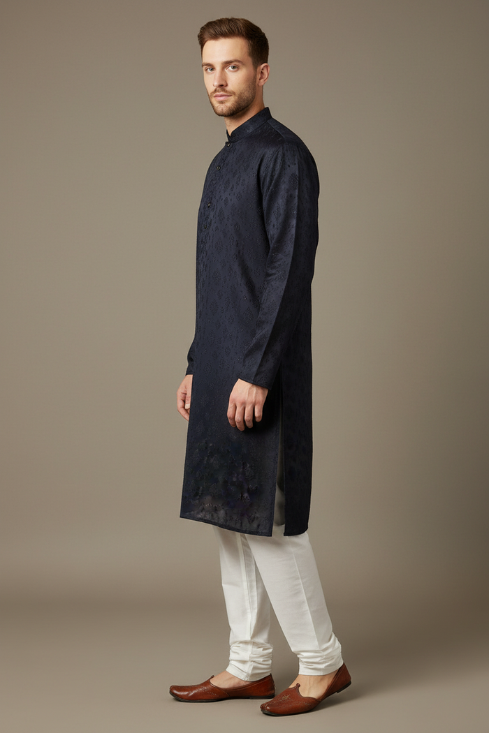 Navy embroidered kurta set side profile on male model with white pajama and mojari footwear