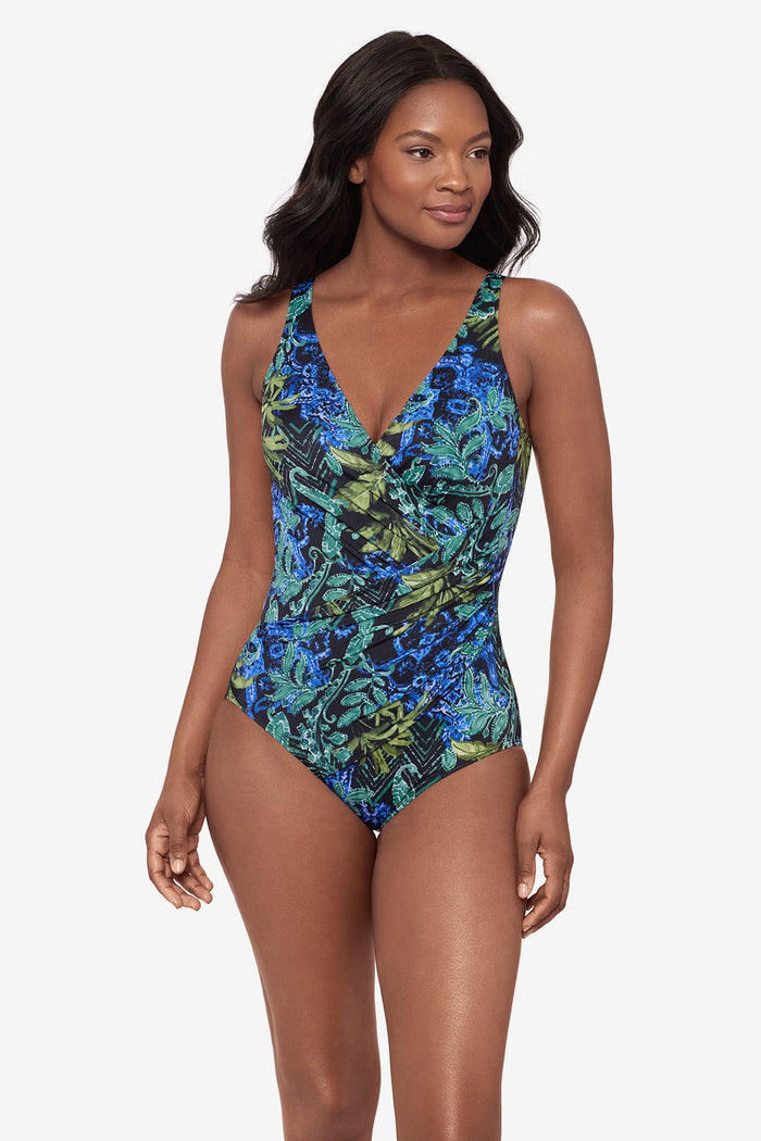 Woman wearing a multicolor abstract print swimsuit with a V neckline