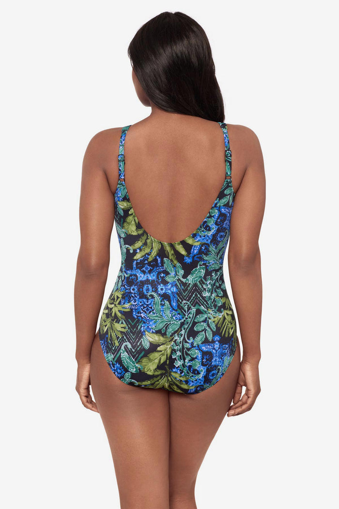 Woman turned away wearing a multicolor abstract print swimsuit with a scoop back