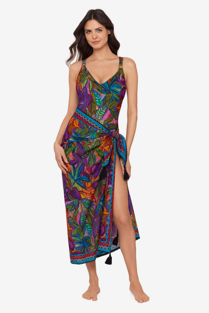 Woman wearing a jungle printed one-piece swimsuit with a matching swim cover up