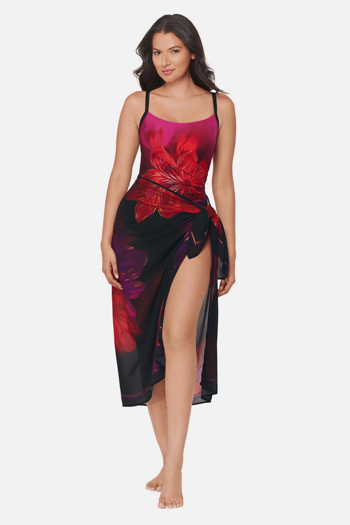 Woman wearing a multicolored floral printed pareo swim cover up with matching swimsuit underneath