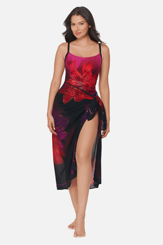 Woman wearing a multicolored floral printed pareo swim cover up with matching swimsuit underneath