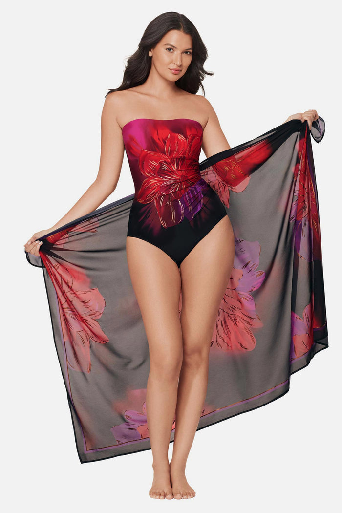 Woman wearing a multicolored floral printed pareo swim cover up with matching swimsuit underneath