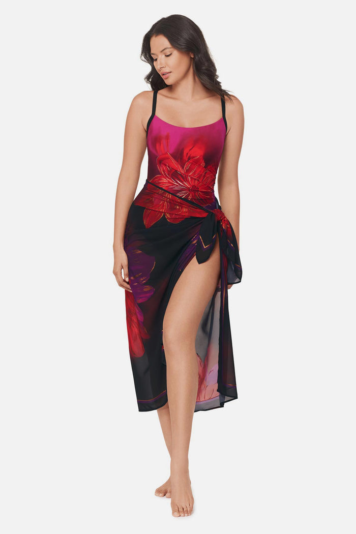 Woman wearing a multicolored floral printed pareo swim cover up with matching swimsuit underneath