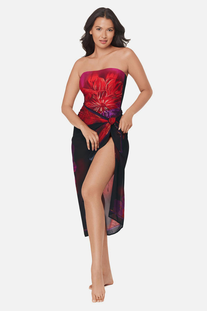 Woman wearing a multicolored floral printed pareo swim cover up with matching swimsuit underneath