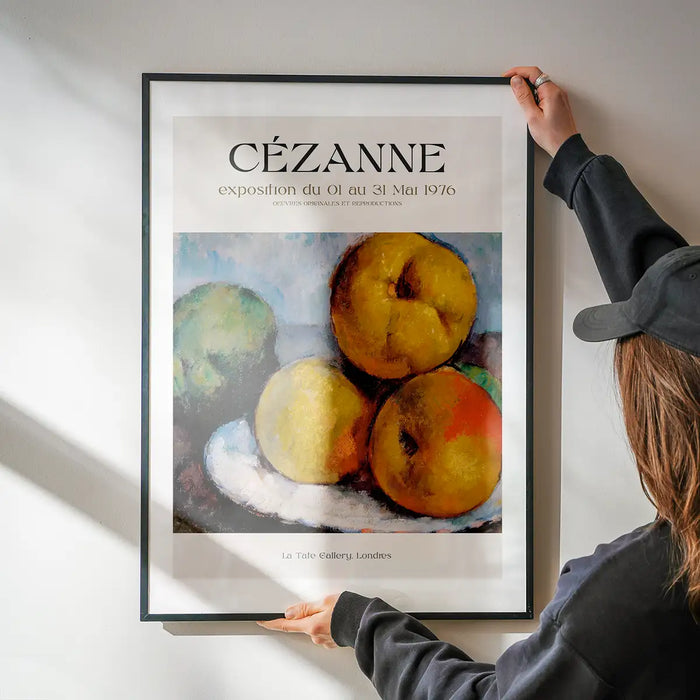 Paul Cézanne Exhibition Museum Poster being hung on a wall in a black frame