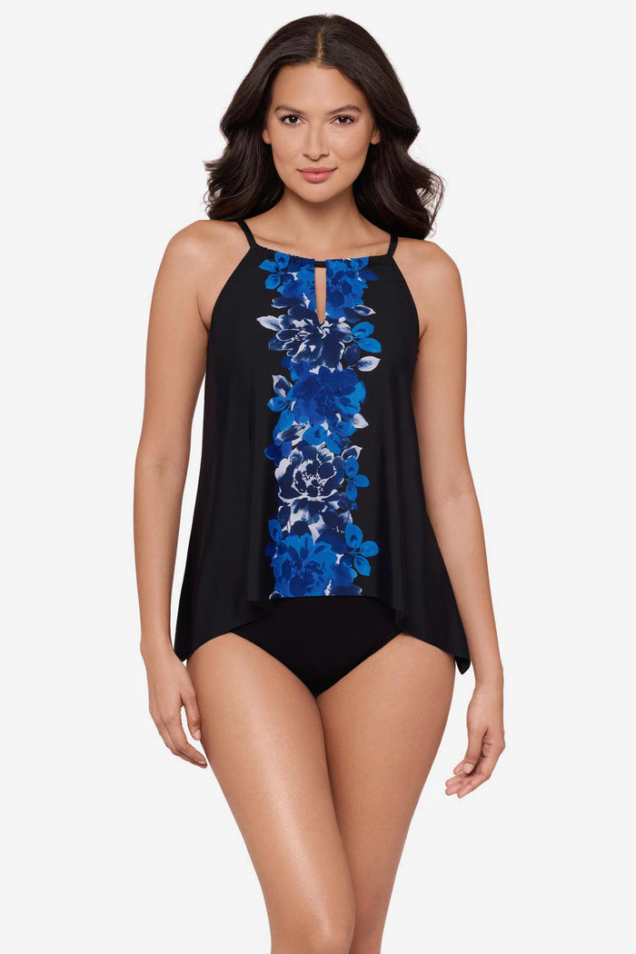 Woman wearing a blue floral print tankini top with peephole neckline
