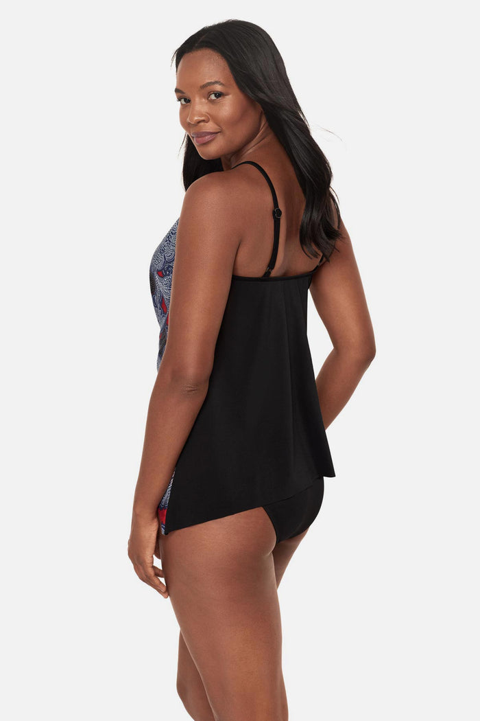 Woman turned left wearing a multicolored abstract floral printed peep hole tankini top